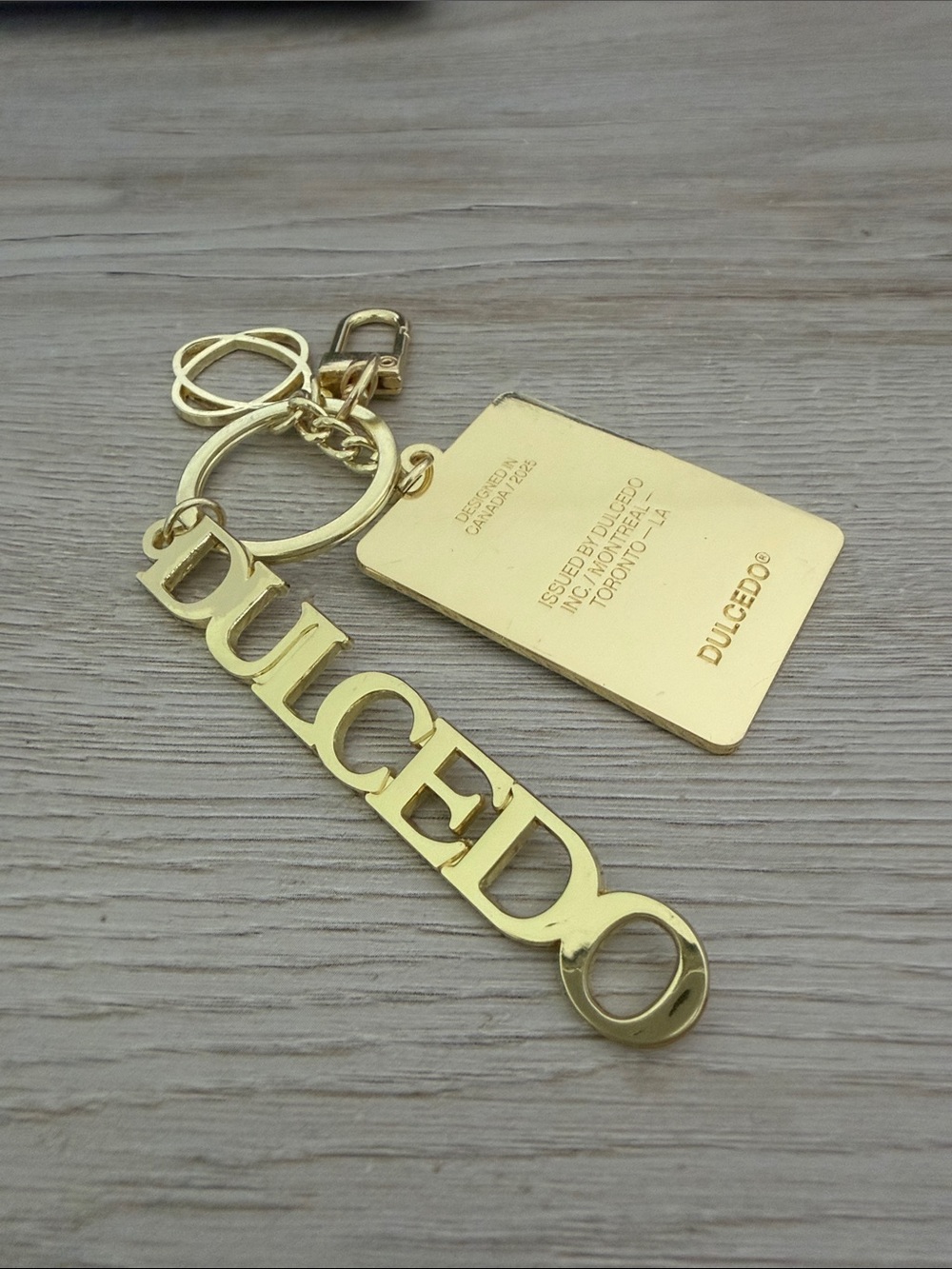 DOLCEDO Gold Tone Logo Keychain